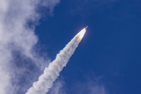 Rocket launching into blue skies.