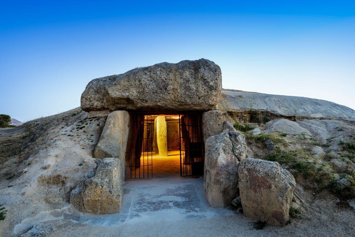 Neolithic stone chamber with illuminated stone inside.