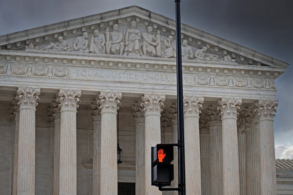 Supreme Court building with pedestrian street sign signaling 