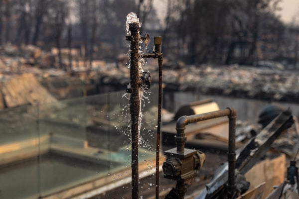Water flows out of the pipes of a collapsed house.