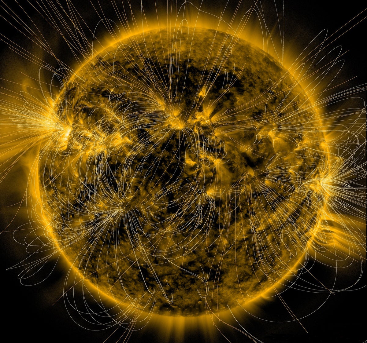 Photo of the sun with magnetic field lines over it.