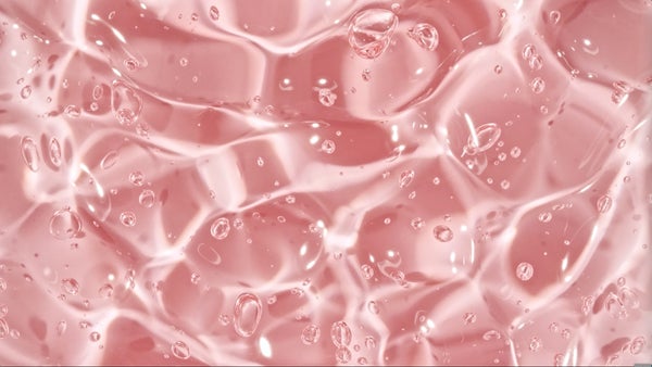 Bubbles of water against a pink background