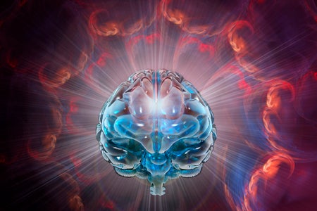 Human brain illuminated by blue light and surrounded by rays of purple light