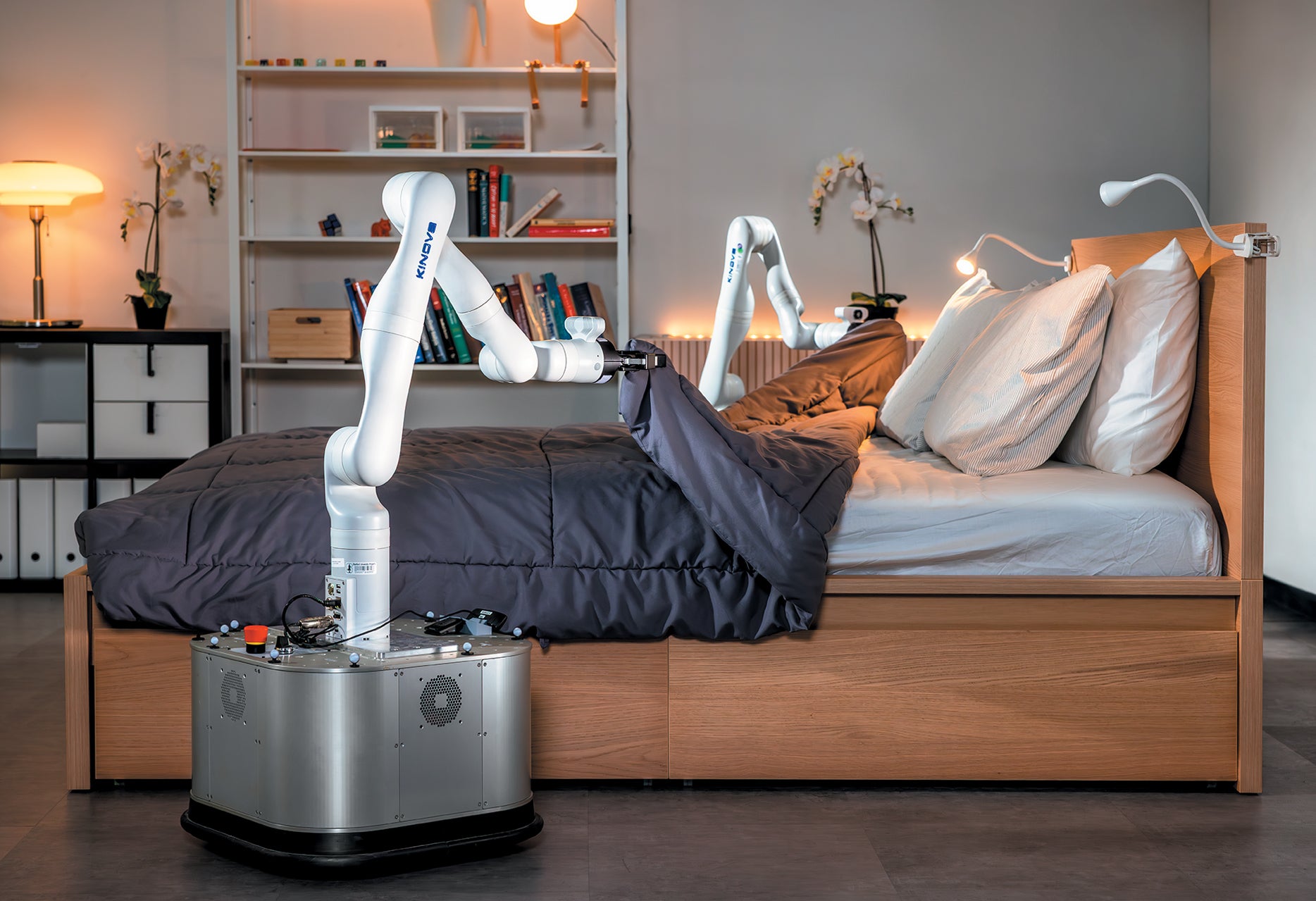 The TidyBot making a bed in a lab