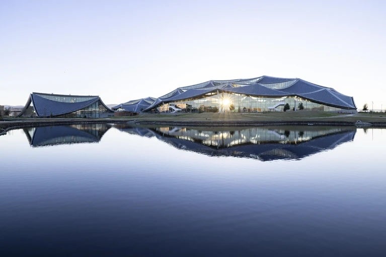 Image of a Google campus building sitting behind a lake