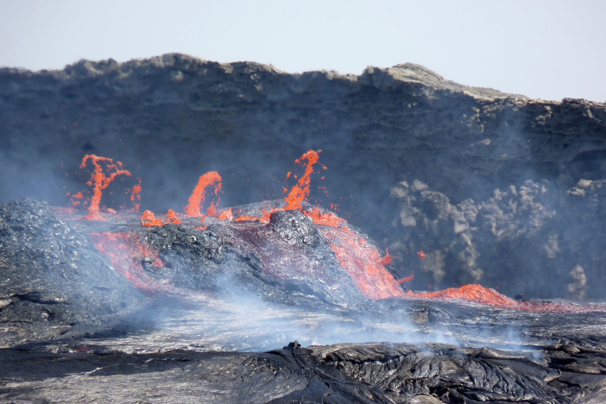 Molten lava spews from erupting volcano