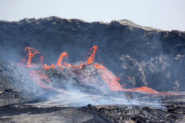 Molten lava spews from erupting volcano