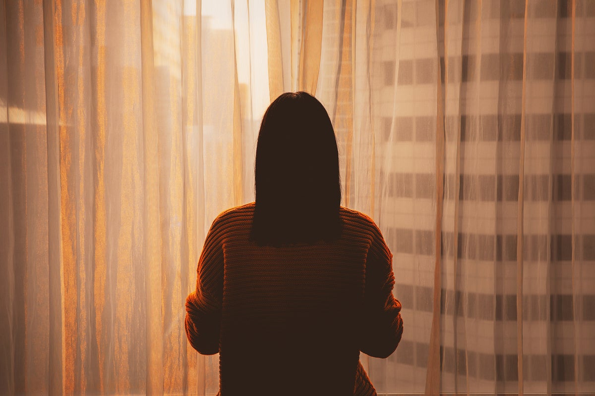 Young woman in front a window