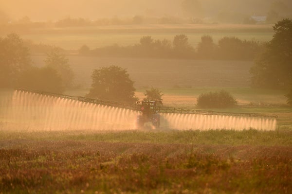 A French farmer sprays glyphosate herbicide "Roundup 720" using a large tractor