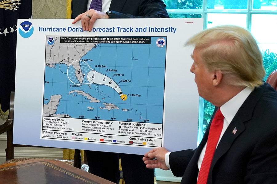 Trump reviewing Hurricane_Dorian_map at Oval Office.