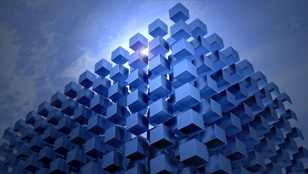 Blue cube pyramid with blue sky background.