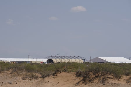 tents and buildings under construction in a field