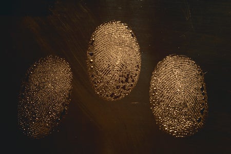 Three fingerprints on a dark background