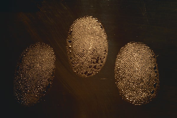 Three fingerprints on a dark background