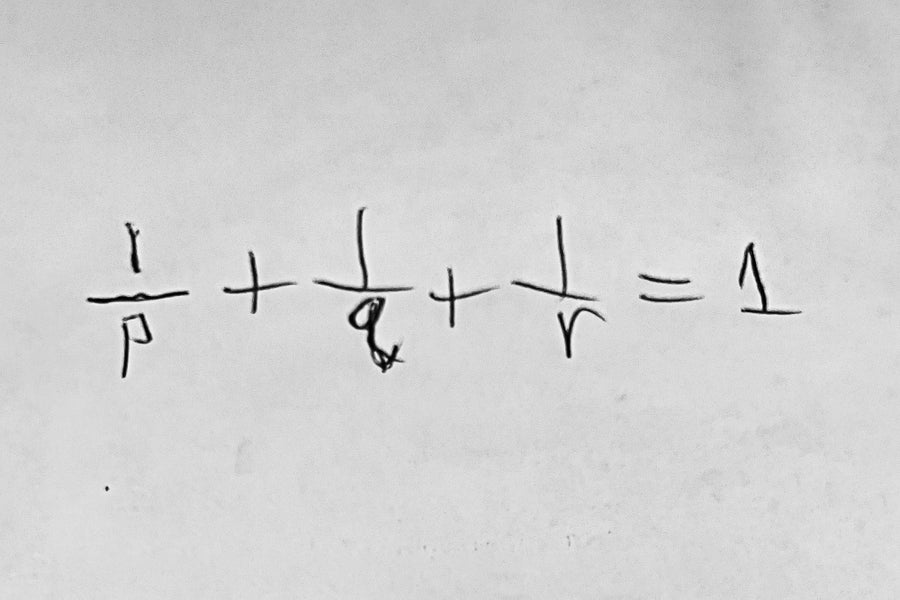 Math equation written in black on white paper.