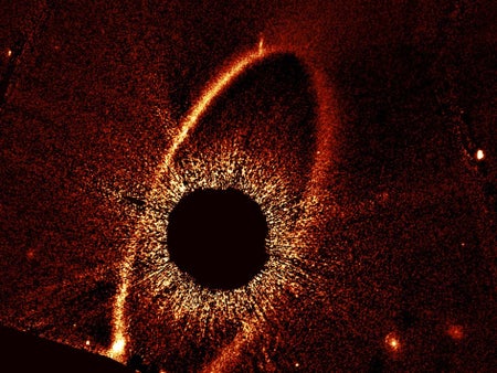 This composite Hubble Space Telescope image shows the debris ring and dust clouds cs1 and cs2 around the star Fomalhaut.