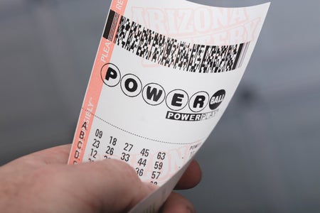 Close up of a hand holding a Powerball ticket