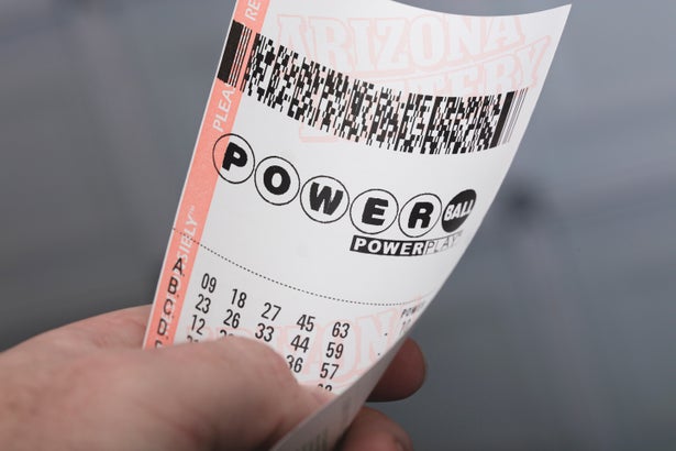 Close up of a hand holding a Powerball ticket