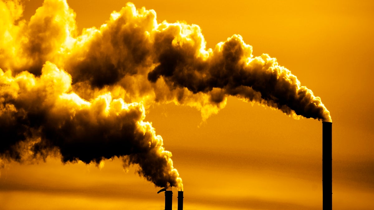 Pollution and smoke from chimneys of factory or power plant belching into atmosphere panorama