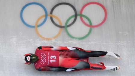 Aerial photo of mens luge athlete and Olympic rings