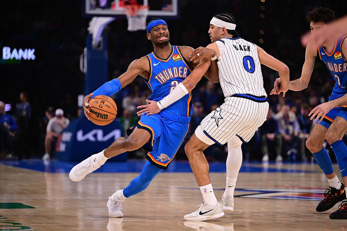 Shai Gilgeous-Alexander blowing plast a defender on the basketball court