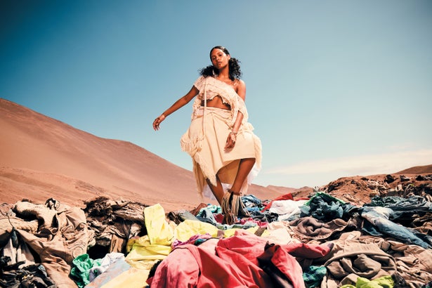 Woman in Atacama desert on pile of clothes