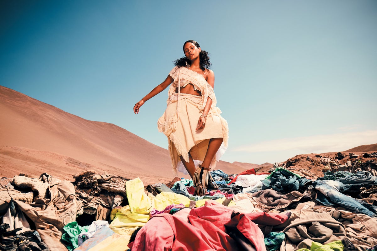 Woman in Atacama desert on pile of clothes