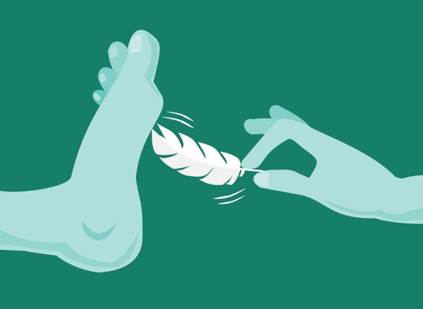 A hand is delicately holding a feather and tickling the bottom of a foot.
