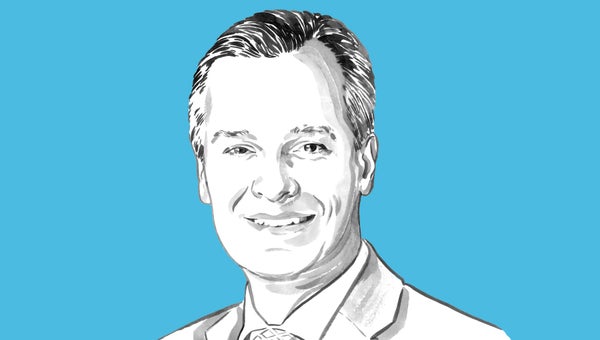 Portrait of Christopher Sharp against a blue background