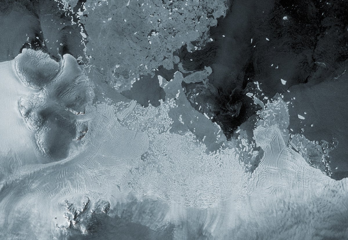 Satellite image shows Antarctica's Thwaites Glacier with lots of blocks of ice broken off and now floating in the ocean nearby.
