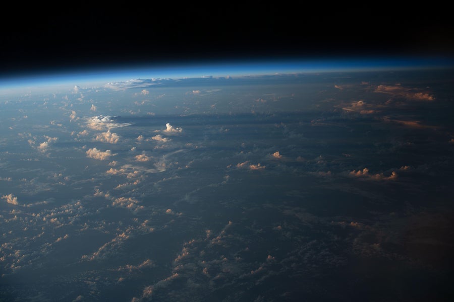 Cloud shadows stretch across the Earth as seen during an orbital sunset from the International Space Station as the habitat soared 258 miles above the Atlantic coast of Suriname in South America.