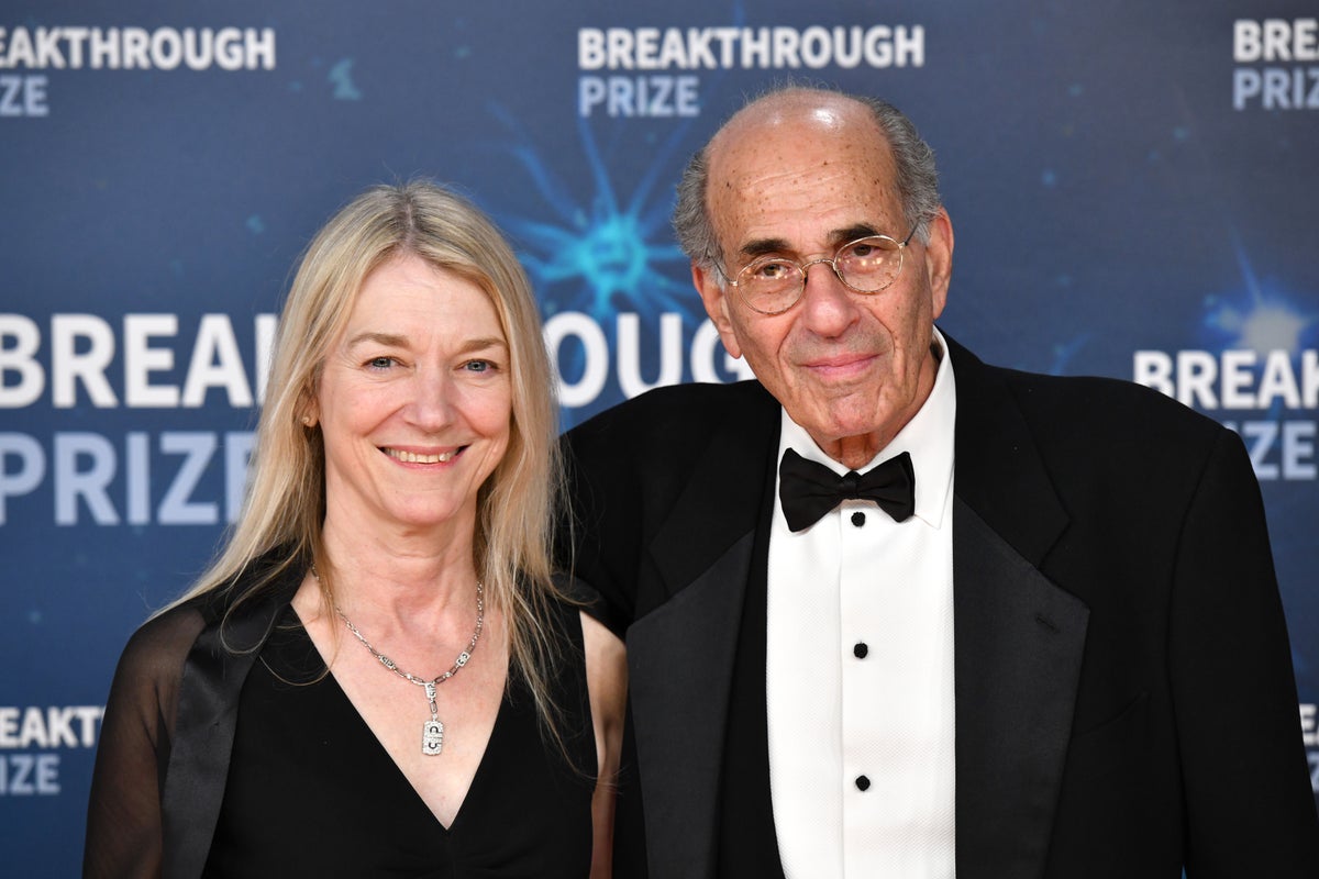Close-up of Richard Axel and Cornelia  standing in front of a Breakthrough Prize backdrop
