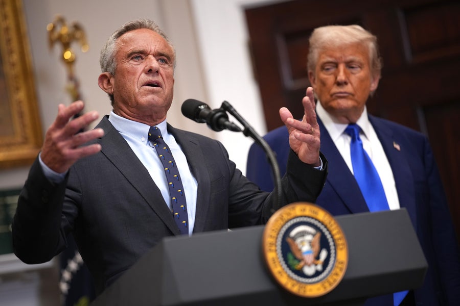 U.S. Health and Human Services Secretary Robert F. Kennedy Jr. speaks at a podium alongside President Donald Trump, seen in the background, during a press conference in the Roosevelt Room of the White House