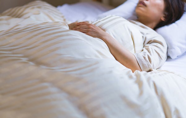 Woman sleeping on white sheets