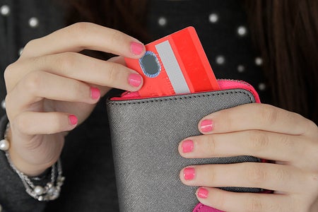 Woman pulling credit card out of purse