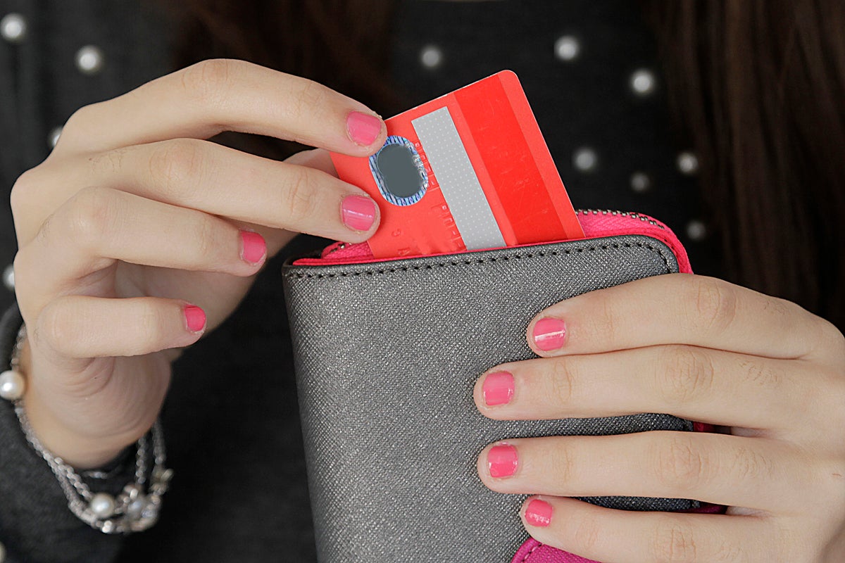 Woman pulling credit card out of purse