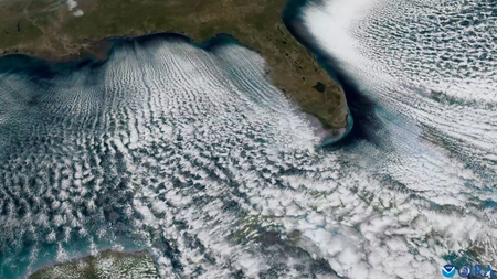 Long lines of clouds streaming out from the shore around Florida