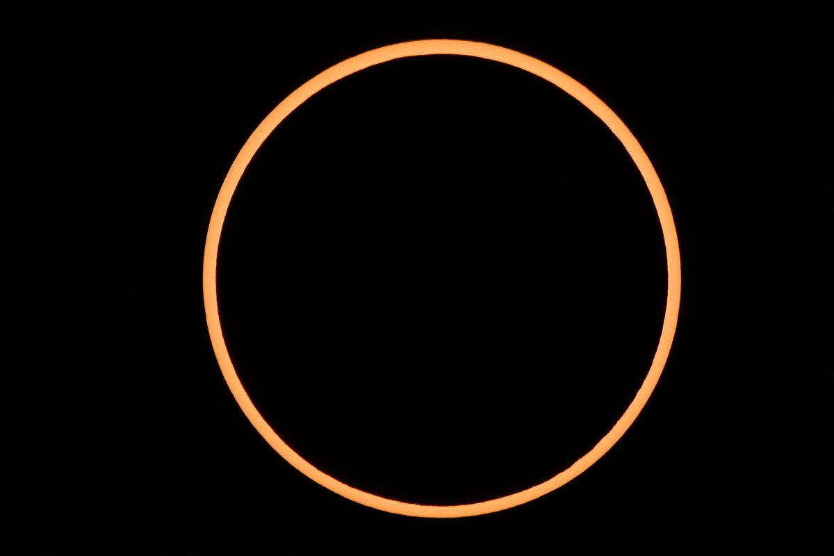 A thin, orange ring outlines a black circle