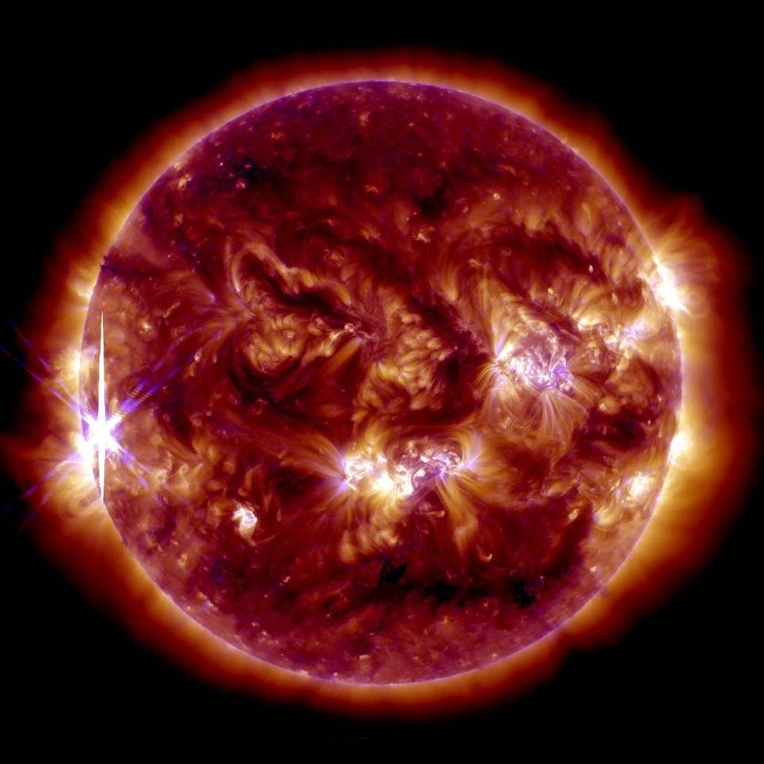 Image of the sun showing turbulent flows of plasma and a bright solar flare.