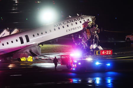 An Air Canada plane crashed at La Guardia airport surrounded by emergency services vehicles