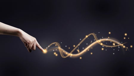A human hand pointing its index finger at a glowing trail of waves against a dark background