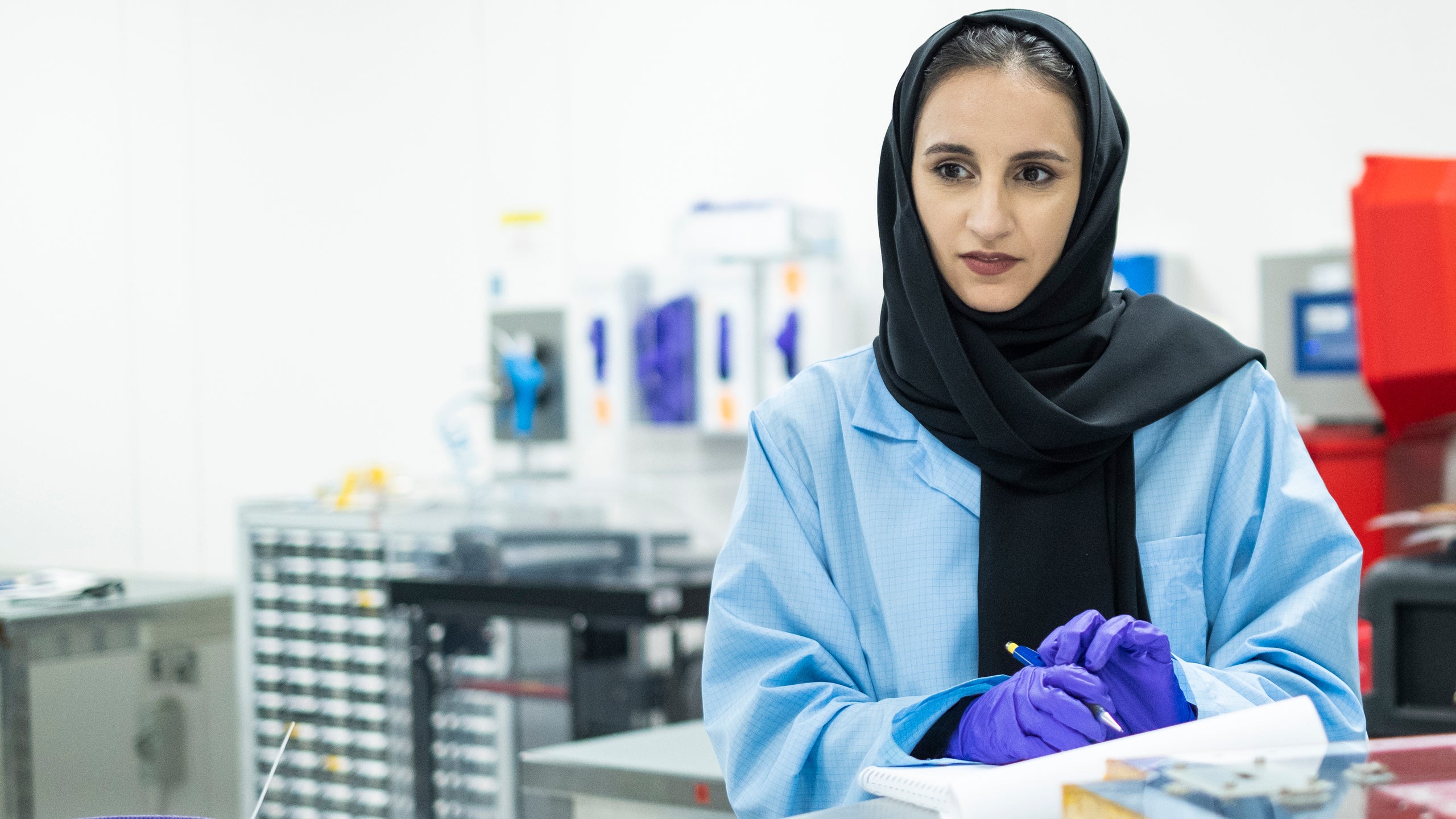 Ayesha Sharafi makes notes in the lab at the The Mohammed Bin Rashid Space Centre