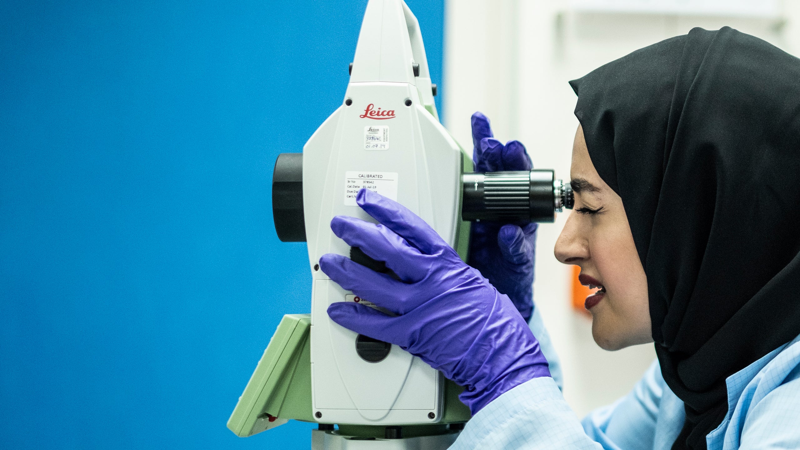 Muna al Hammadi looks through the viewfinder of a measuring machine