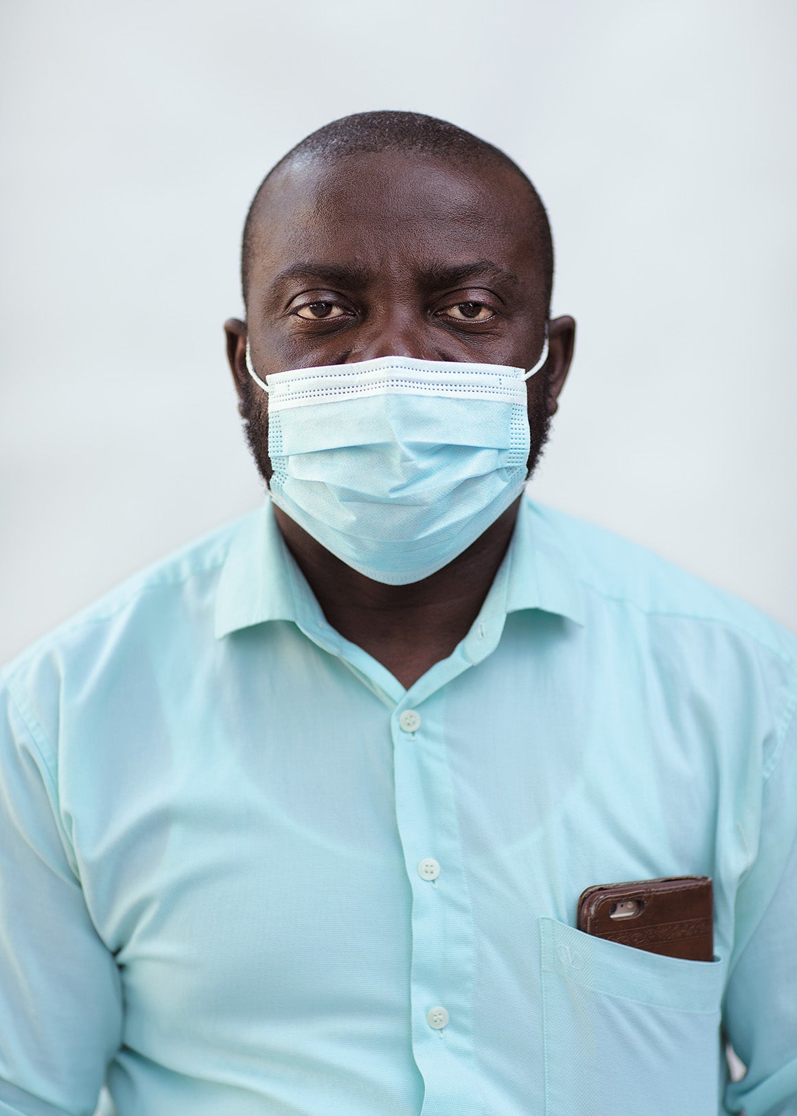 Alex Appiah Frimpong wearing a blue shirt and face mask.