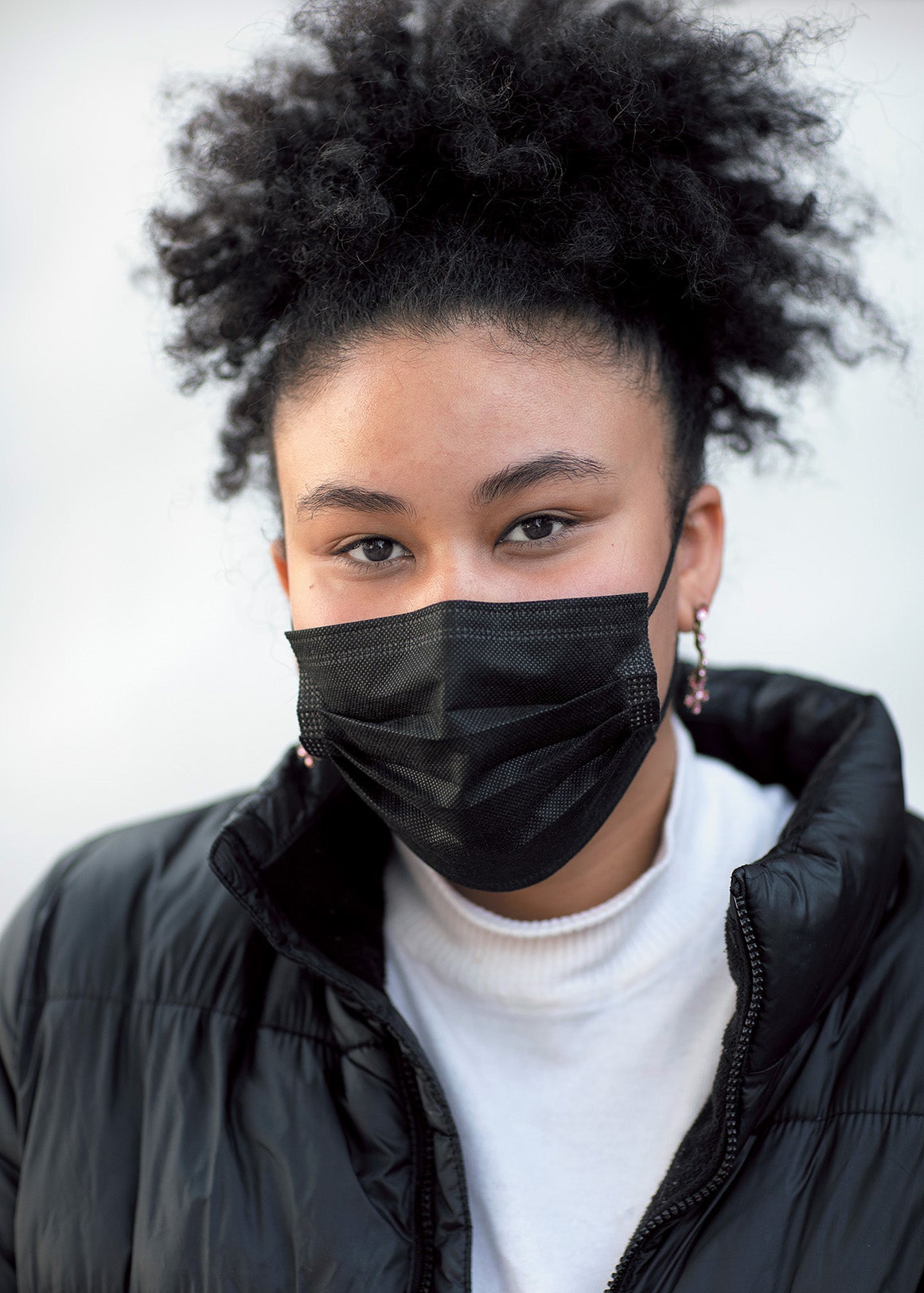 Layla Sayed, a young woman, wearing a face mask.