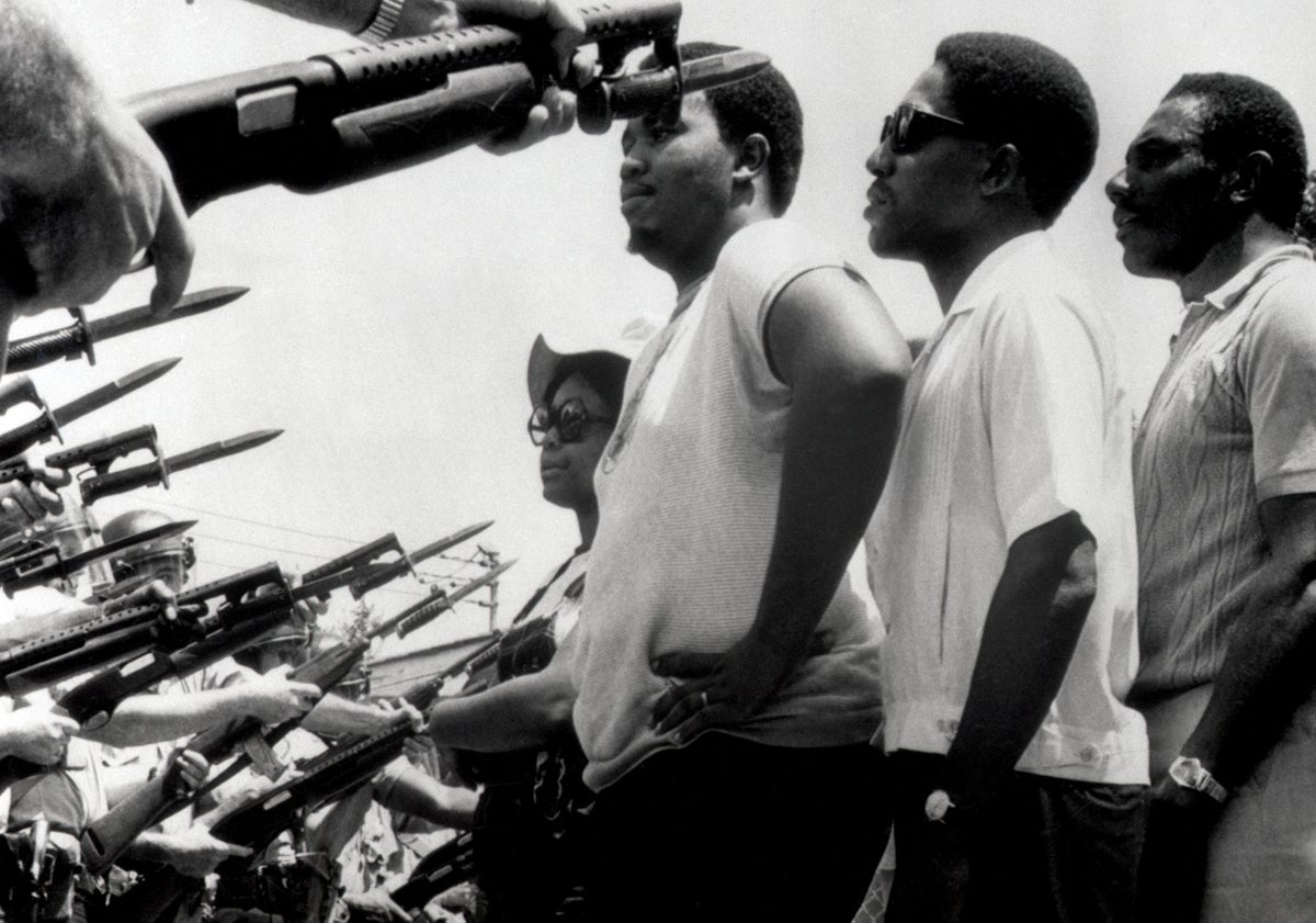 BAYONETS wielded by police officers halt unarmed protesters seeking to reach city hall in Prichard, Ala., in June 1968