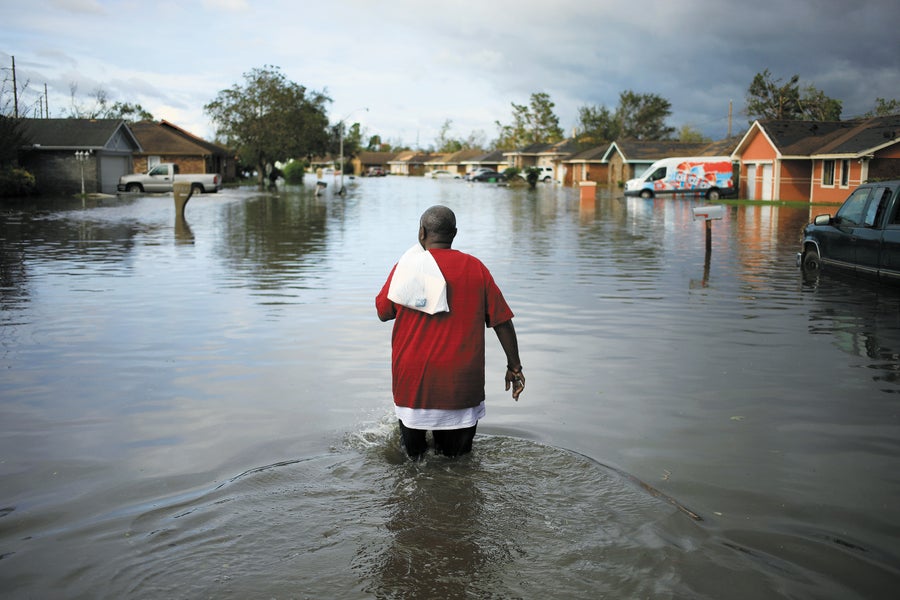 Black man walking in flooded street in LaPlace, La after Hurricane Ida.
