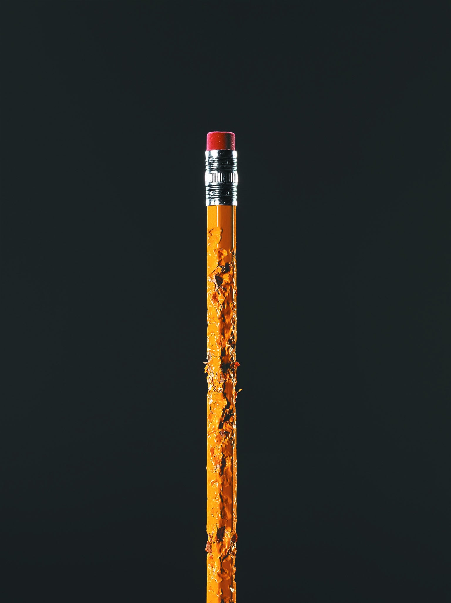 Yellow pencil against dark background.