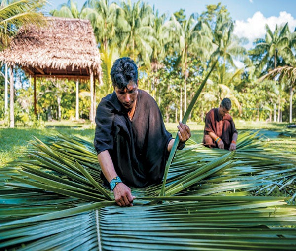 Man weaving palm leaves.