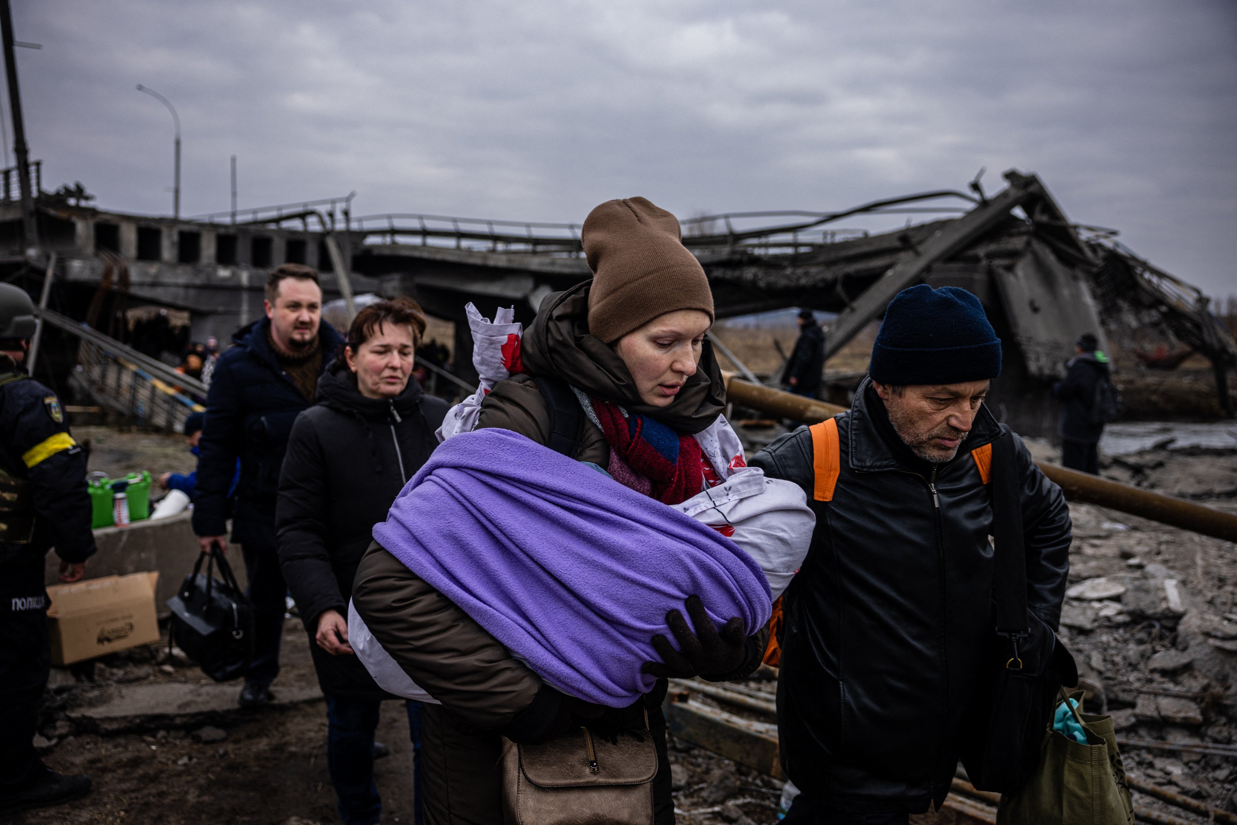 Ukrainians flee the city of Irpin.